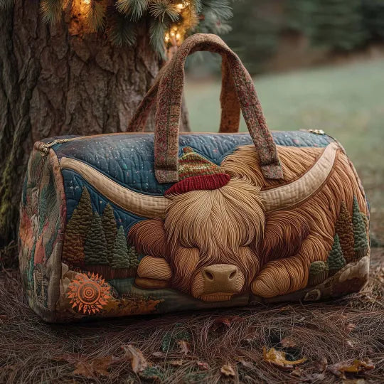 Gesteppte Reisetasche mit zotteligem schottischem Hochlandrind vor Tannen